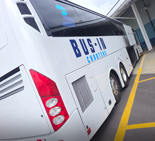 White charter bus parked outside